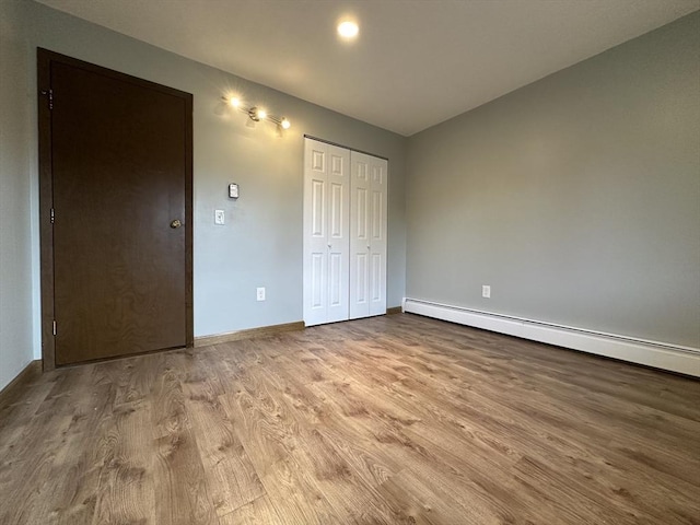 82 S Maple St Unit 44, Westfield, MA 01085 - unfurnished bedroom featuring a baseboard radiator, wood finished floors, and a closet