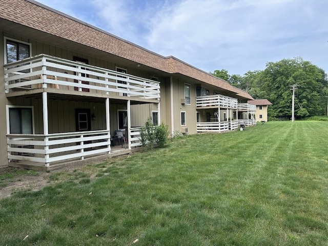 82 S Maple St Unit 44, Westfield, MA 01085 - back of property with a shingled roof, board and batten siding, and a lawn