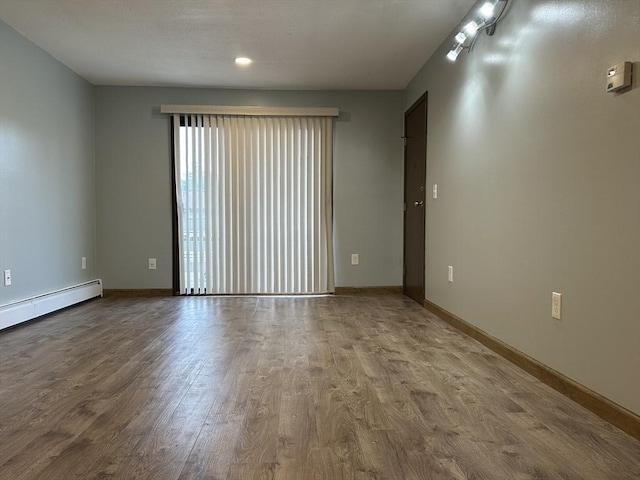 82 S Maple St Unit 44, Westfield, MA 01085 - empty room featuring wood finished floors and a baseboard heating unit