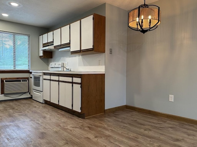 82 S Maple St Unit 44, Westfield, MA 01085 - kitchen with white electric stove, wood finished floors, a chandelier, white cabinetry, and light countertops