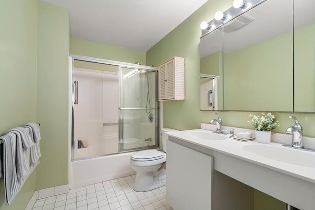 full bathroom featuring enclosed tub / shower combo, vanity, tile patterned floors, and toilet