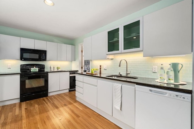 kitchen with white cabinetry, light wood-type flooring, sink, and black appliances