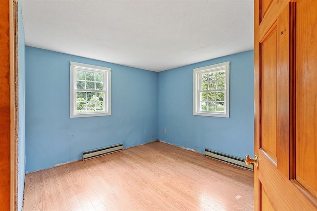 336 Otter River Rd, Templeton, MA 01468 - empty room featuring a baseboard radiator, baseboard heating, light wood-style flooring, and plenty of natural light