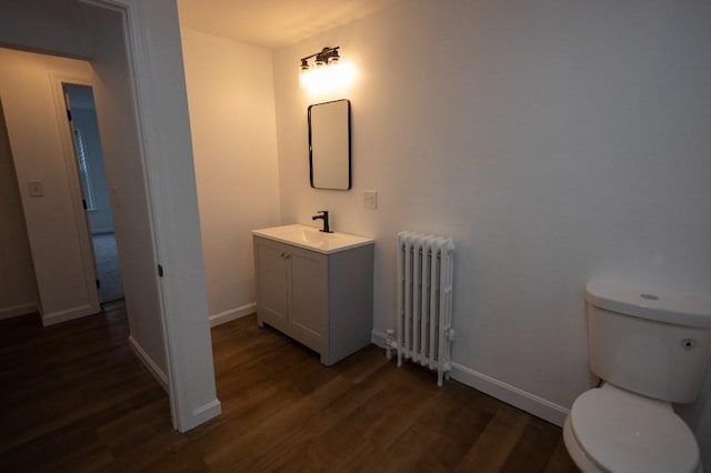 23 Highland St, Townsend, MA 01469 - half bath with radiator, wood finished floors, vanity, toilet, and baseboards