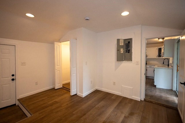 23 Highland St, Townsend, MA 01469 - unfurnished bedroom featuring electric panel, lofted ceiling, a sink, dark wood-type flooring, and baseboards