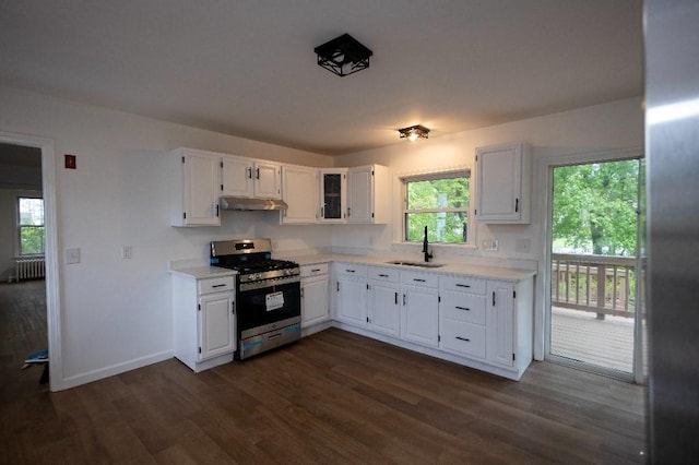 23 Highland St, Townsend, MA 01469 - kitchen featuring gas stove, a sink, under cabinet range hood, radiator heating unit, and light countertops