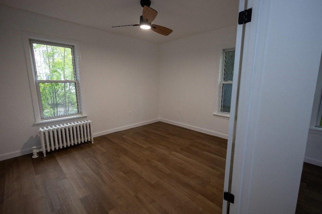 23 Highland St, Townsend, MA 01469 - empty room featuring radiator heating unit, dark wood-type flooring, a ceiling fan, and baseboards