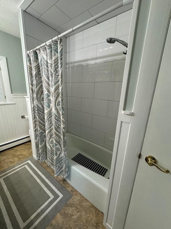 64 Edgewater Dr, Wareham, MA 02571 - bathroom with shower / bathtub combination with curtain, visible vents, a baseboard radiator, and a wainscoted wall