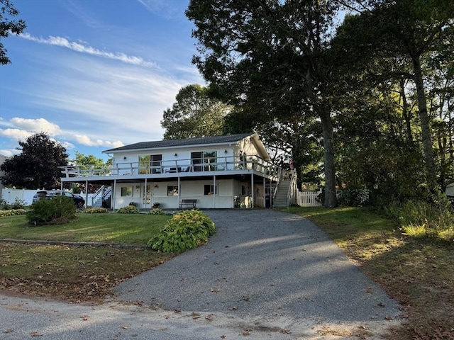 64 Edgewater Dr, Wareham, MA 02571 - view of front of house with stairway, driveway, a front yard, a wooden deck, and fence