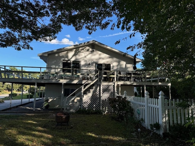 64 Edgewater Dr, Wareham, MA 02571 - rear view of house with stairway, a deck, fence, and an outdoor fire pit