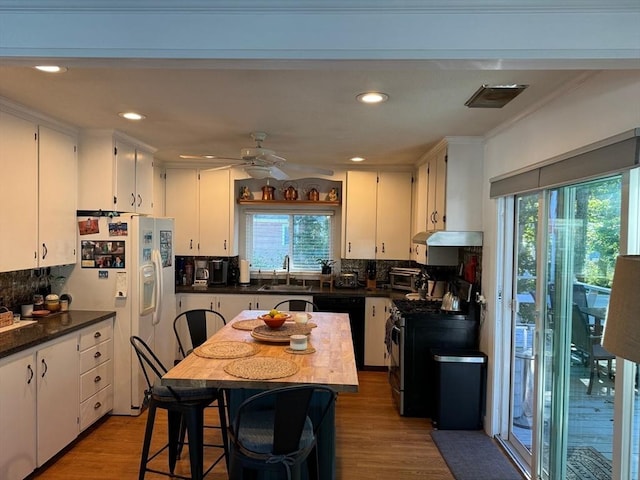 64 Edgewater Dr, Wareham, MA 02571 - kitchen featuring white cabinetry, stainless steel gas stove, plenty of natural light, and white fridge with ice dispenser