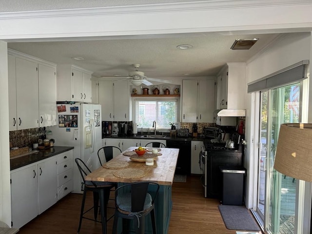 64 Edgewater Dr, Wareham, MA 02571 - kitchen featuring a ceiling fan, dishwasher, dark countertops, stainless steel gas range oven, and decorative backsplash