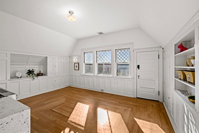 interior space with light parquet floors and lofted ceiling