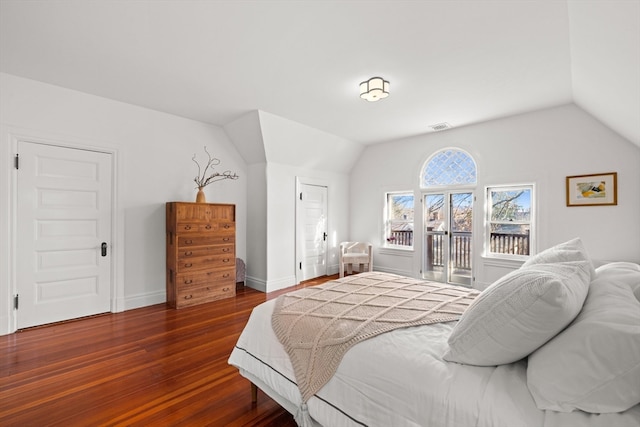 bedroom featuring lofted ceiling and dark wood-type flooring