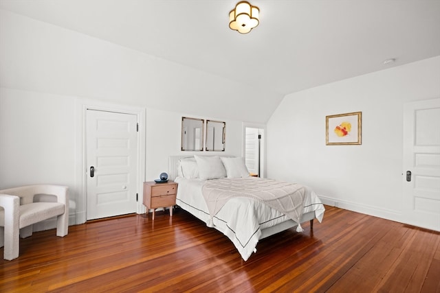 bedroom with dark hardwood / wood-style flooring and vaulted ceiling