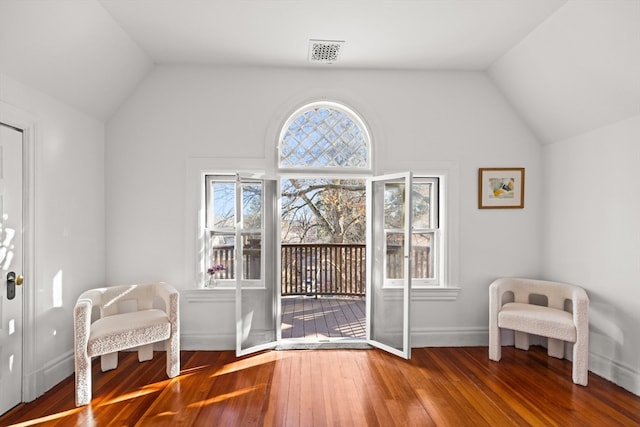 sitting room featuring hardwood / wood-style floors and vaulted ceiling