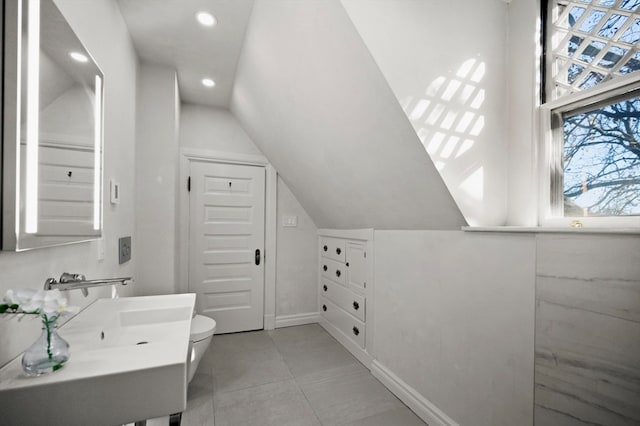 bathroom with vanity, toilet, and vaulted ceiling