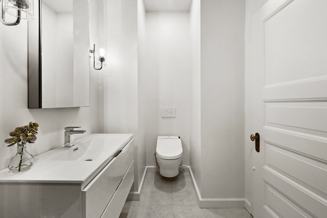 bathroom featuring toilet, vanity, and tile patterned floors