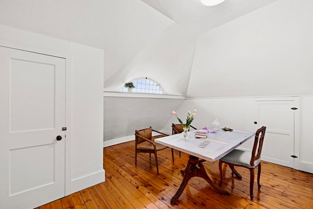 office space featuring lofted ceiling and light hardwood / wood-style flooring