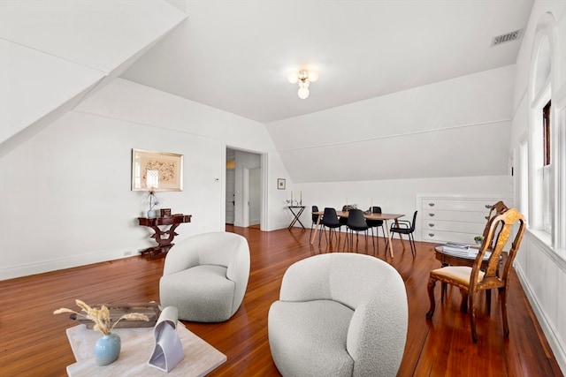 sitting room featuring hardwood / wood-style floors and vaulted ceiling