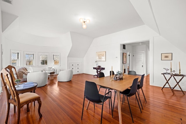 dining area featuring hardwood / wood-style floors and lofted ceiling