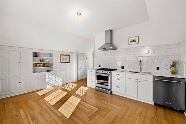 kitchen with decorative backsplash, wall chimney range hood, sink, and appliances with stainless steel finishes