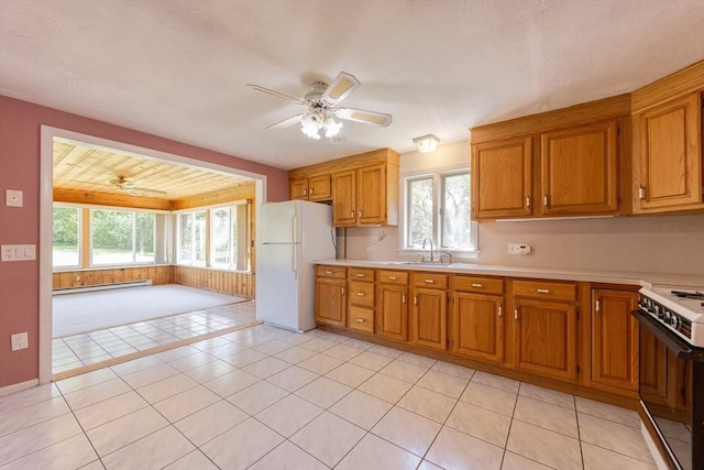 4 Cypress Rd, Natick, MA 01760 - kitchen featuring freestanding refrigerator, a baseboard heating unit, range, and a ceiling fan