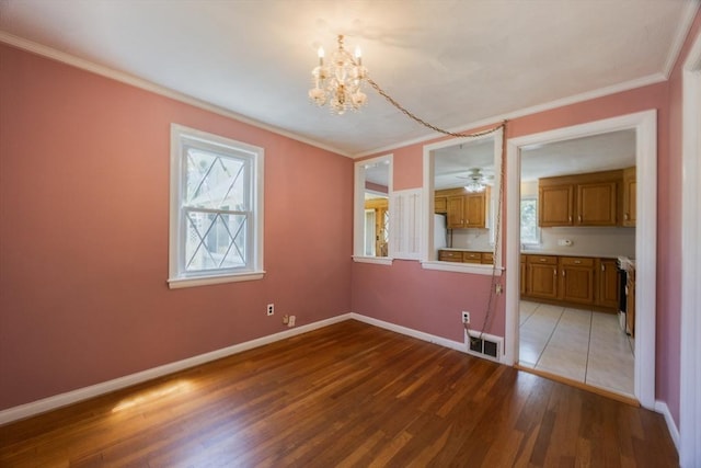 4 Cypress Rd, Natick, MA 01760 - empty room with light wood-style flooring, a chandelier, crown molding, and baseboards