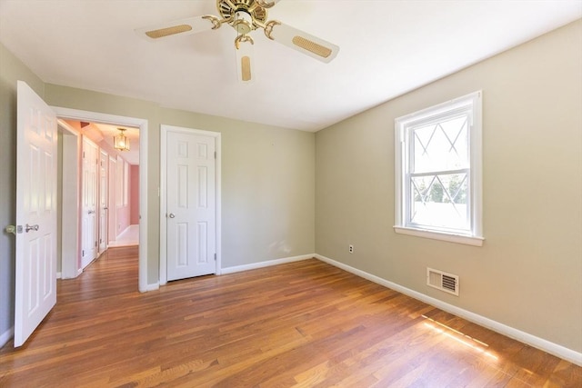 4 Cypress Rd, Natick, MA 01760 - unfurnished bedroom featuring baseboards, wood finished floors, ceiling fan, and a chandelier