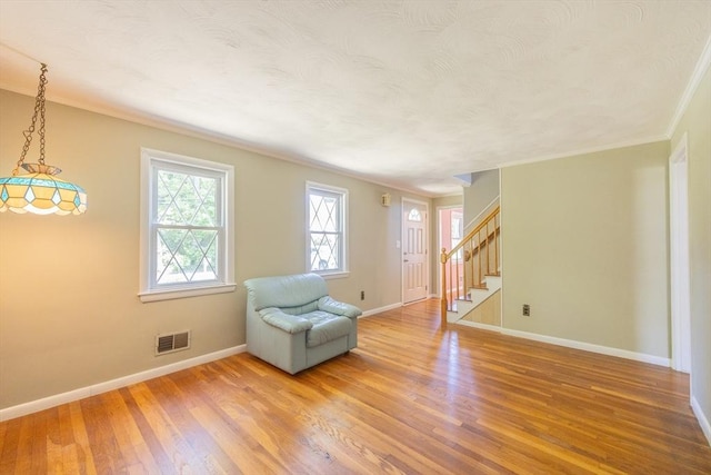 4 Cypress Rd, Natick, MA 01760 - living area with wood finished floors, ornamental molding, stairway, baseboards, and a textured ceiling
