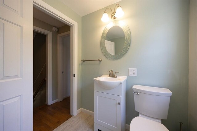 4 Cypress Rd, Natick, MA 01760 - bathroom with vanity, wood finished floors, toilet, and baseboards