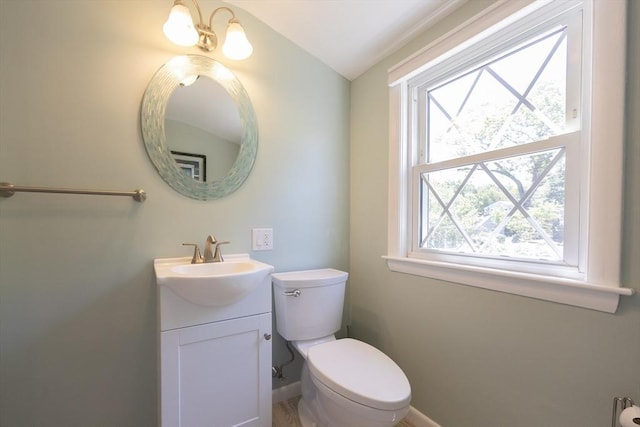 4 Cypress Rd, Natick, MA 01760 - half bathroom with vanity, toilet, vaulted ceiling, and baseboards