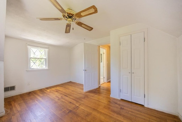 4 Cypress Rd, Natick, MA 01760 - unfurnished bedroom with wood finished floors, a ceiling fan, a closet, baseboards, and lofted ceiling