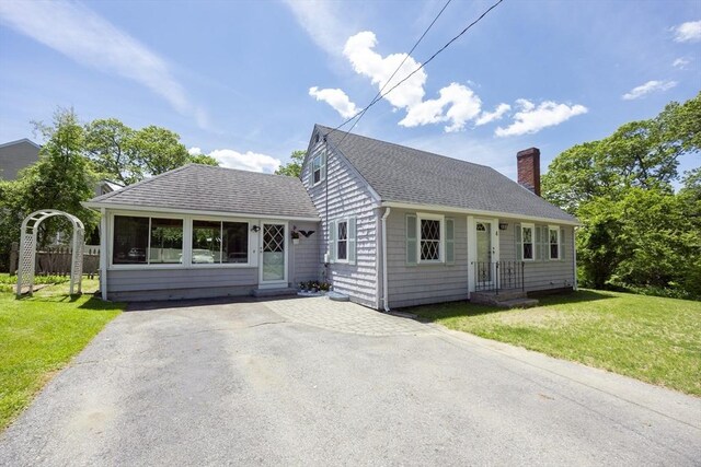 4 Cypress Rd, Natick, MA 01760 - view of front of house featuring a chimney, a shingled roof, a front yard, and driveway