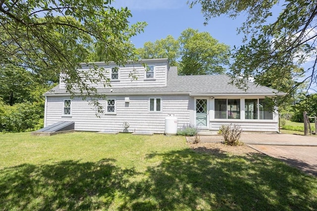 4 Cypress Rd, Natick, MA 01760 - back of property featuring a yard, a sunroom, and roof with shingles