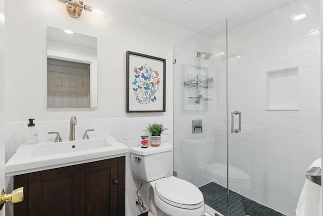 35 Nonantum St Unit E, Boston, MA 02135 - full bath featuring tile walls, toilet, vanity, a shower stall, and wainscoting
