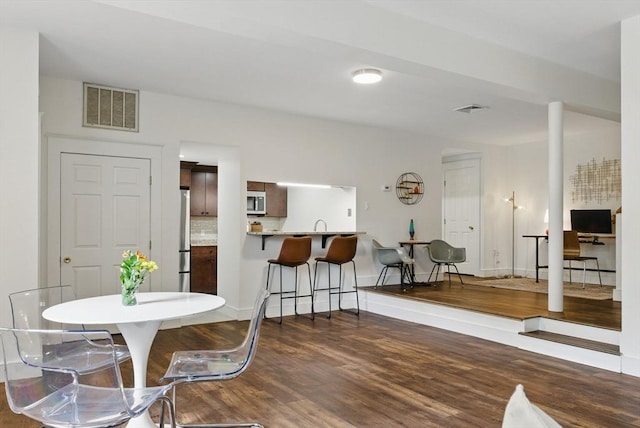 35 Nonantum St Unit E, Boston, MA 02135 - dining space with dark wood-type flooring and baseboards