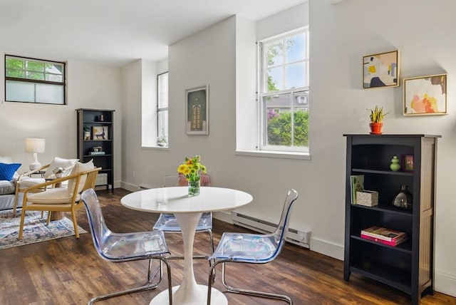 35 Nonantum St Unit E, Boston, MA 02135 - dining area featuring a baseboard heating unit, wood finished floors, and baseboards
