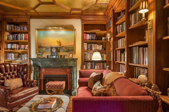 living area with crown molding and built in shelves