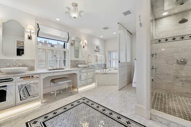 bathroom featuring double sink vanity, plus walk in shower, tile flooring, and a chandelier