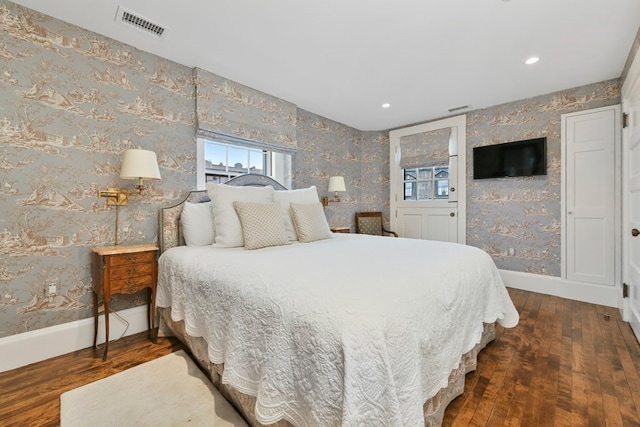 bedroom with dark hardwood / wood-style floors