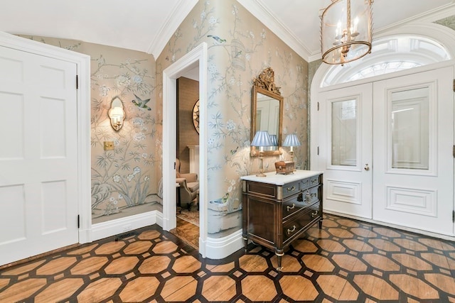 tiled foyer featuring a notable chandelier, crown molding, and vaulted ceiling