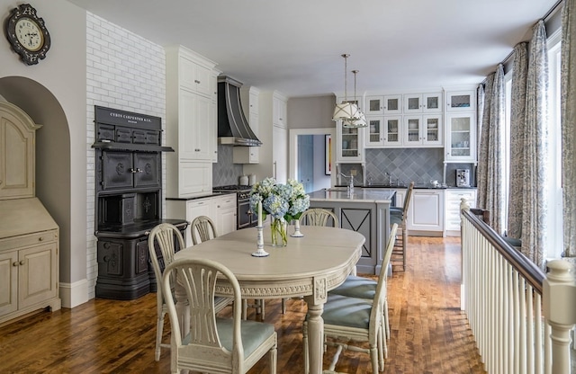 dining area featuring a notable chandelier and dark wood-type flooring