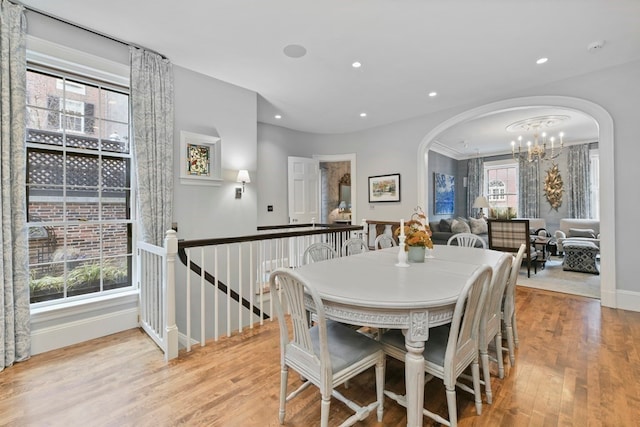 dining area featuring a chandelier, light hardwood / wood-style floors, and plenty of natural light