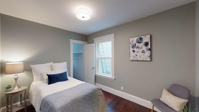 bedroom featuring baseboards and dark wood finished floors