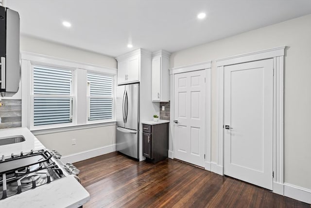 kitchen featuring dark wood-style flooring, recessed lighting, stainless steel fridge, and white cabinets