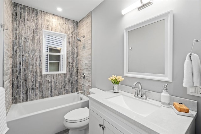 bathroom with toilet, vanity, and washtub / shower combination