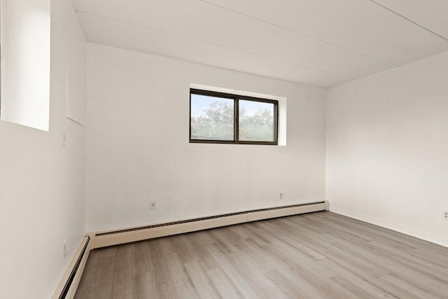 995 Massachusetts Ave Unit 301, Arlington, MA 02476 - unfurnished room with a baseboard heating unit and wood finished floors