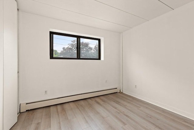 995 Massachusetts Ave Unit 301, Arlington, MA 02476 - spare room featuring a baseboard heating unit and light wood-type flooring