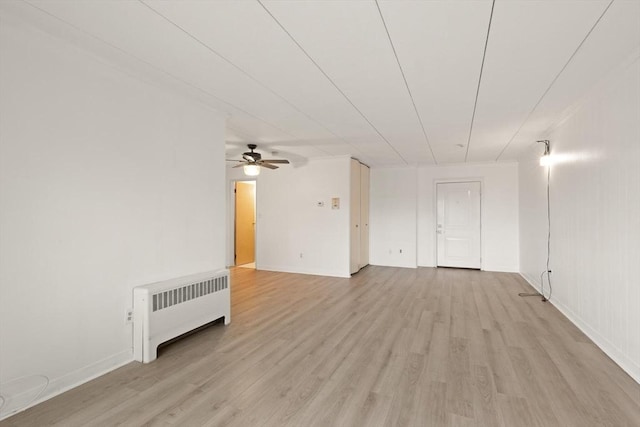 995 Massachusetts Ave Unit 301, Arlington, MA 02476 - spare room with radiator heating unit, light wood-style flooring, and ceiling fan